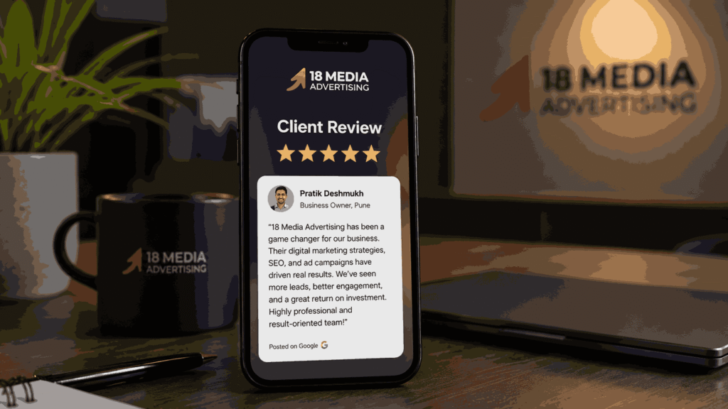 Smartphone displaying a five-star client testimonial for a digital marketing company in Vishrantwadi Pune reviews with 18 Media Advertising branding on a professional office desk