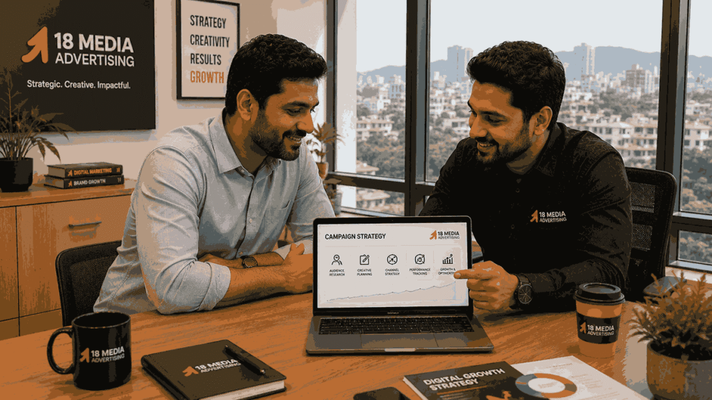 Online advertising agency near me consultation showing a Pune business owner discussing campaign strategy with an 18 Media Advertising consultant in a modern office.
